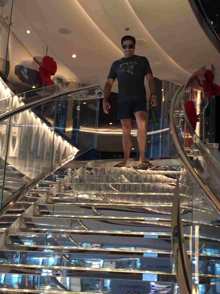 SkyTC founder Valtersky walking down the iconic Swarovski crystal staircase on an MSC luxury cruise ship.